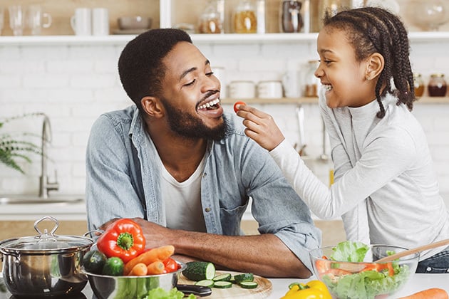 dad and child enjoying healthy food
