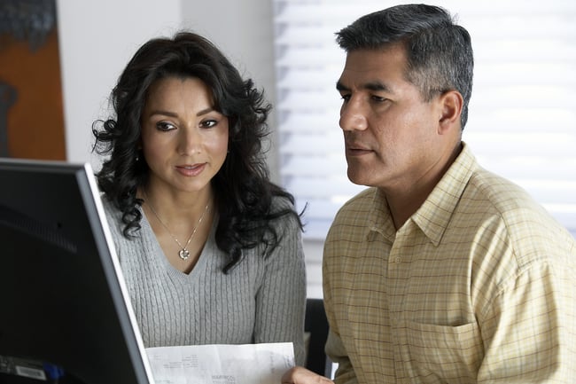 couple with bill at computer