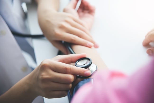 nurse checking blood pressure
